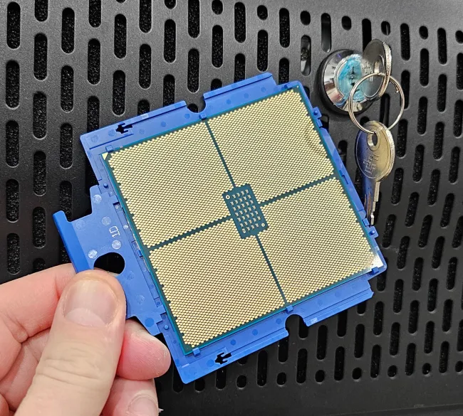 AMD EPYC 9005 CPU next to a lock